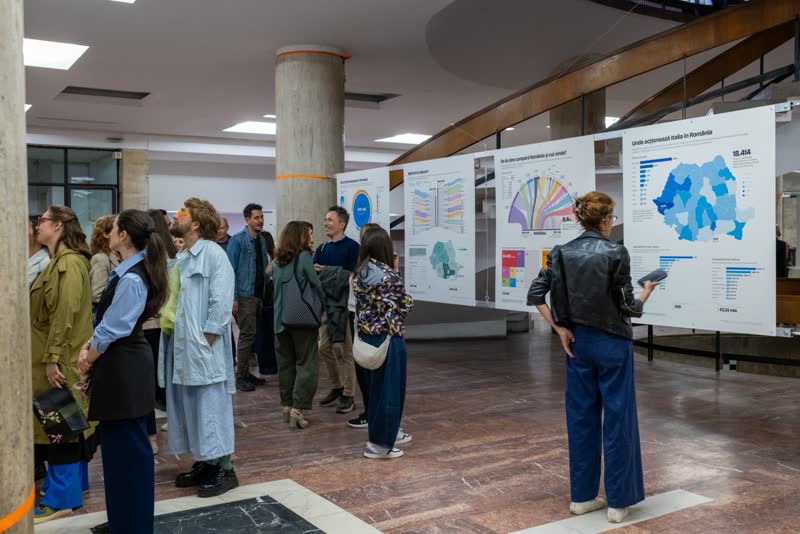 A crowd gathers among the panels on opening night.
