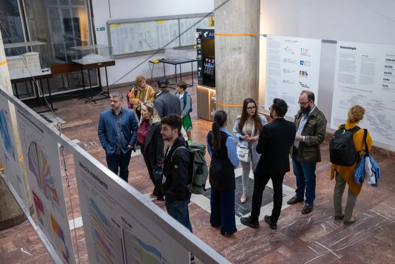 Visitors talk in small groups by the methodology panel.